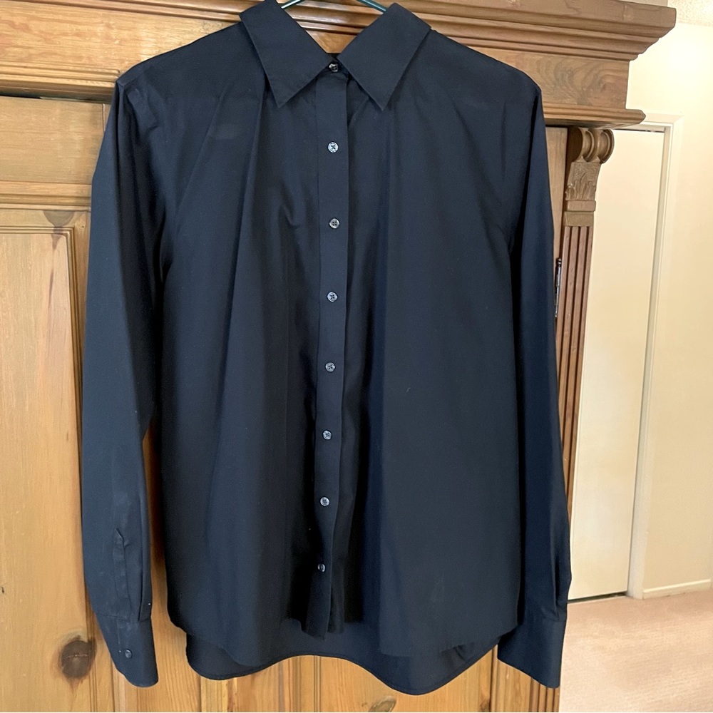 Never worn. Crisp black blouse. As basic a piece as it comes.
